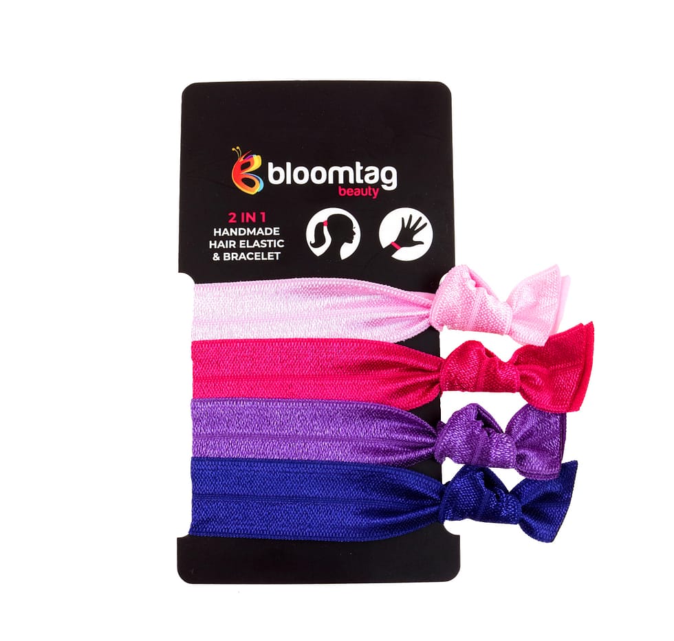 Bloomband Set of hair elastics in shades of pink, purple and navy blue.