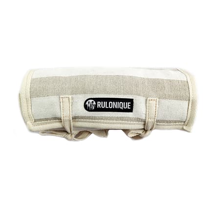 Rulonique linen cosmetic orgnizer. Rolled up showing its stripes and logo.